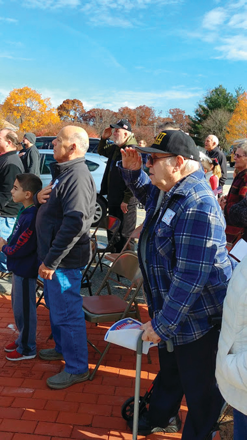 A SPECIAL SALUTE: Veterans including Frank Kay and Martin Normann could be seen saluting the flag and listening to the WHMS band play the Star Spangled Banner.